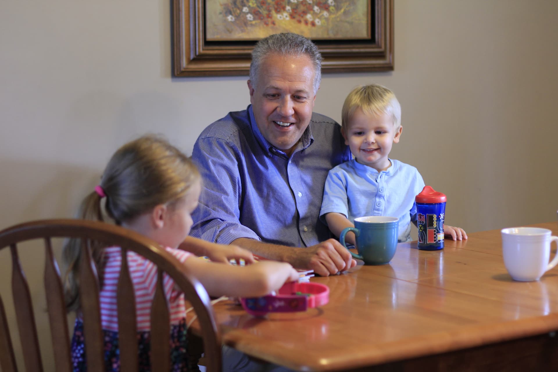 Mike Gaskill at the kitchen table with two of his grandchildren