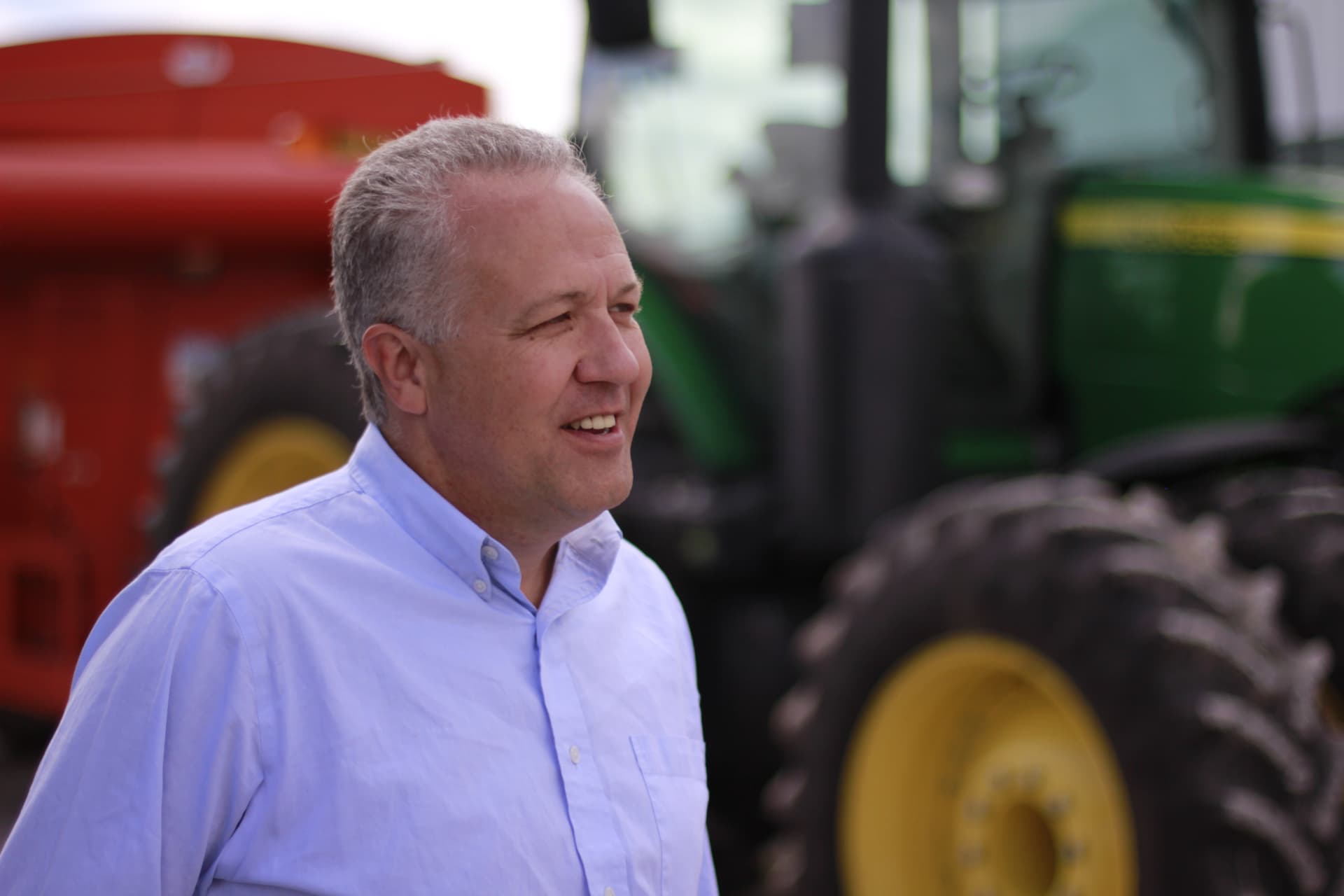 Mike Gaskill visiting with neighbors at a farm in Senate District 25